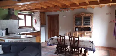 a kitchen and dining room with a table and chairs at Vakantiehuisje 't Morehof in Oosterzele