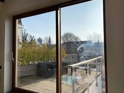 a sliding glass door with a view of a balcony at Burgstraat 17 Apartment in Exclusive Patrician House in Medieval Ghent in Ghent