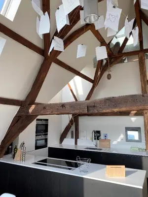 a kitchen with wooden beams and paper notes hanging from the ceiling at Burgstraat 17 Apartment in Exclusive Patrician House in Medieval Ghent in Ghent