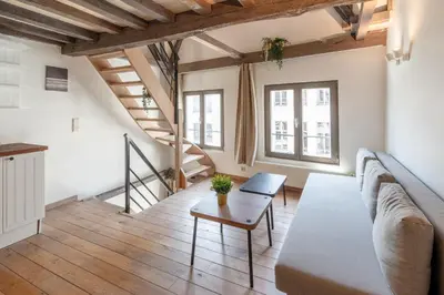 a living room with a couch and a table at Tempel Cathedral Lodge in the Heart of Antwerp in Antwerp
