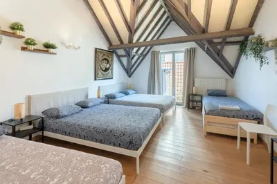 a bedroom with three beds in a room at Tempel Cathedral Lodge in the Heart of Antwerp in Antwerp