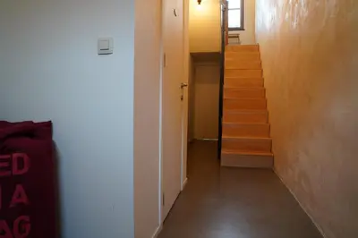 a hallway with a staircase and a stair case at Well-situated and Comfortable Home in Ghent