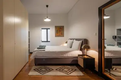 a bedroom with a bed and a mirror at Fish Market Apartments in Brussels