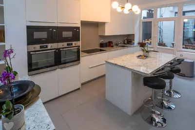 a large kitchen with white cabinets and a counter top at Fish Market Apartments in Brussels