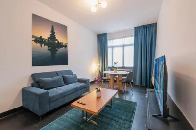 a living room with a couch and a table at Fish Market Apartments in Brussels