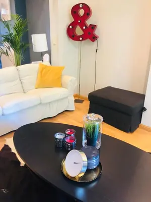 a coffee table in a living room with a white couch at Apartment Easyway to sleep in Brussels