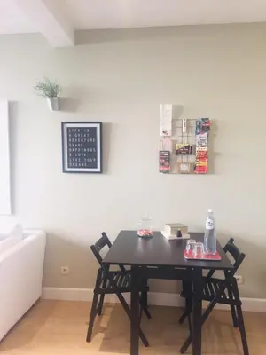 a table with two chairs in a living room at Apartment Easyway to sleep in Brussels