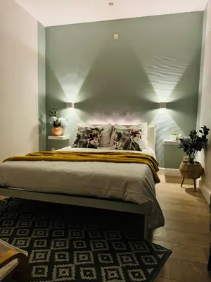 a bedroom with a bed with a blue wall at Apartment Easyway to sleep in Brussels