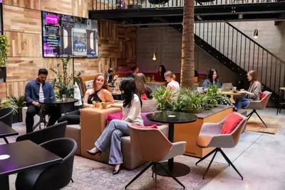 a group of people sitting in a restaurant at Moxy Brussels City Center in Brussels