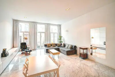 a living room with a couch and a table at Saint Pauls Lodge in Antwerp
