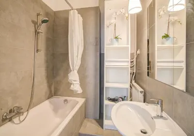 a bathroom with a tub and a sink and a shower at The National Lodge in Antwerp