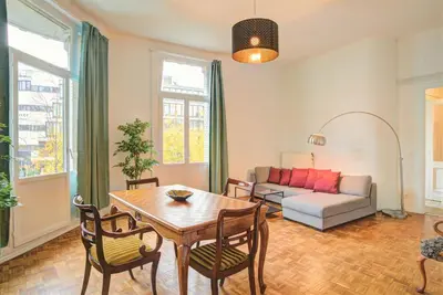 a living room with a table and chairs and a couch at The National Lodge in Antwerp