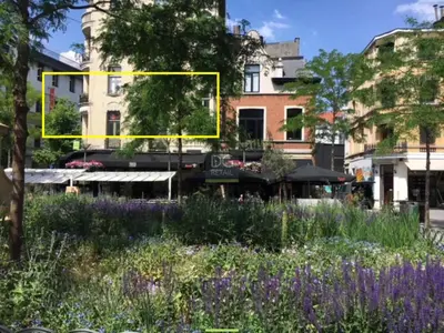 a yellow rectangle in the middle of a garden with flowers at The National Lodge in Antwerp