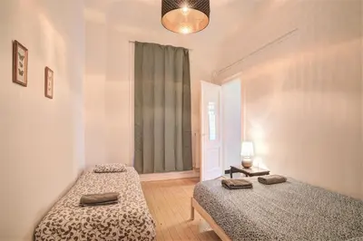 a bedroom with two beds and a window at The National Lodge in Antwerp