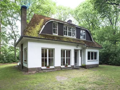 a white house with a black roof at Westmalle Forest Garden Home in Zoersel