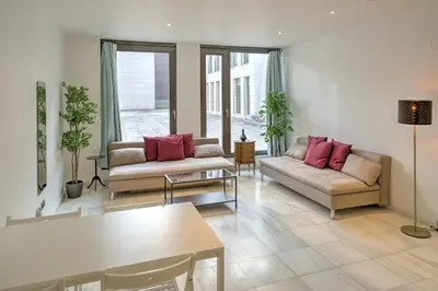 a living room with two couches and a table at The Antwerp Marble Lodge in Antwerp