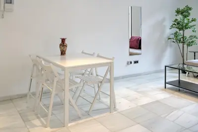 a white table and chairs in a room at The Antwerp Marble Lodge in Antwerp