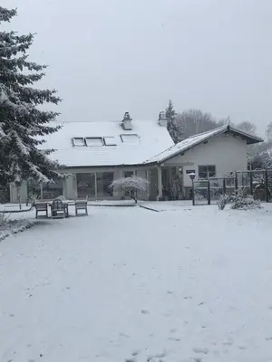 a snow covered building with benches in a yard at Aquavilla Bed & Breakfast in Willebroek