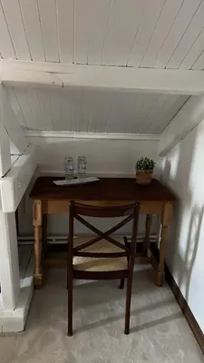 a wooden table with two glasses and a plant on it at Aquavilla Bed & Breakfast in Willebroek