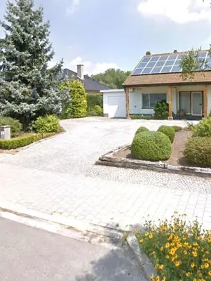 a driveway with a house with a solar roof at Aquavilla Bed & Breakfast in Willebroek
