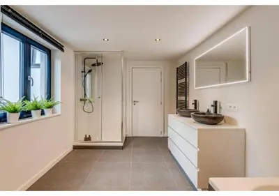 a bathroom with a sink and a counter with a mirror at The Heart of Leuven in Leuven