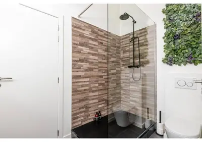 a bathroom with a glass shower with a toilet at The Heart of Leuven in Leuven