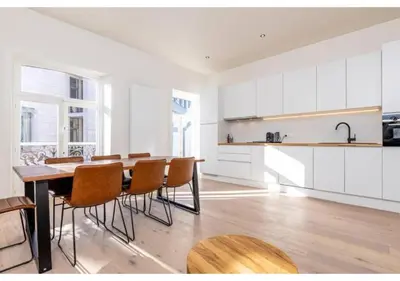 a kitchen with a table and chairs in a room at The Heart of Leuven in Leuven