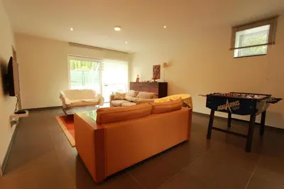 a living room with a couch and a pool table at NUVOLA HOUSE in Zottegem