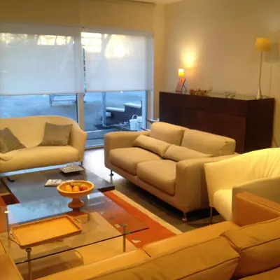a living room with two couches and a table at NUVOLA HOUSE in Zottegem