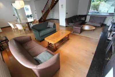 a living room with a couch and chairs and a table at NUVOLA VILLA in Zottegem