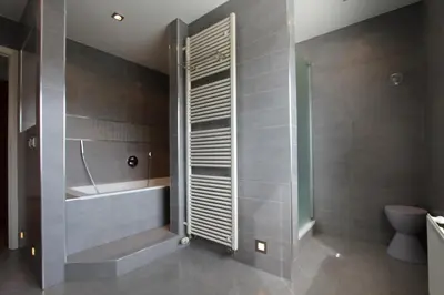 a bathroom with a shower and a tub and a toilet at NUVOLA VILLA in Zottegem
