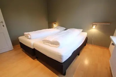 a large bed with white sheets and towels on it at NUVOLA VILLA in Zottegem