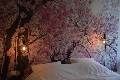 a bedroom with a cherry blossom tree wall at B&B Tantine in Retie