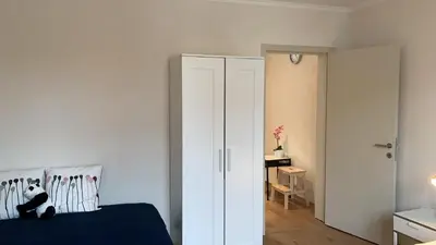 a bedroom with a bed and a white closet at Panda Stella in Zaventem