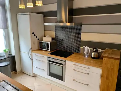 a kitchen with a white refrigerator and a microwave at Grand Appartement Jourdan EU in Brussels