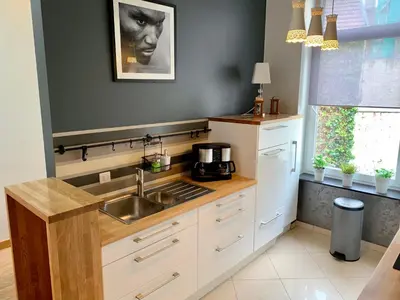 a kitchen with a sink and a counter top at Grand Appartement Jourdan EU in Brussels