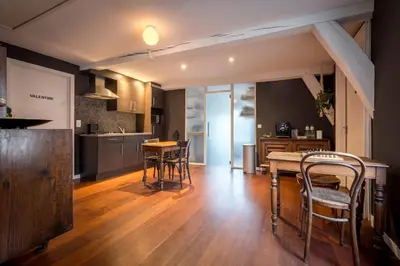 a kitchen and dining room with a table and chairs at The Piano Guesthouse - Kwaadham52 in Ghent