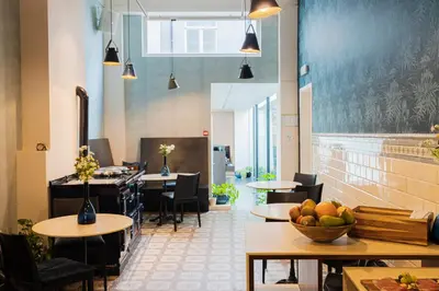 a restaurant with tables and chairs and fruit on tables at The Piano Guesthouse - Kwaadham52 in Ghent