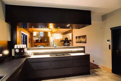 a kitchen with a large mirror above a counter at 't Averhuys in Itegem