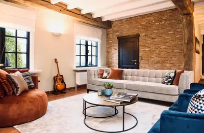 a living room with a couch and a table at 't Averhuys in Itegem