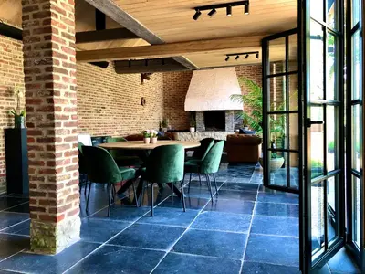 a dining room with a table and chairs at 't Averhuys in Itegem