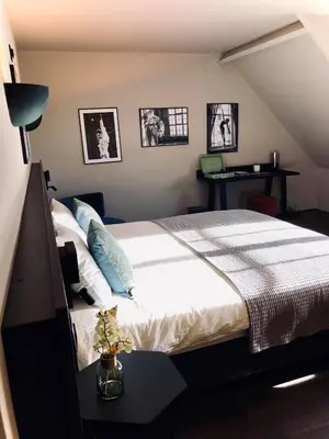 a bedroom with a bed and a desk with a laptop at 't Averhuys in Itegem