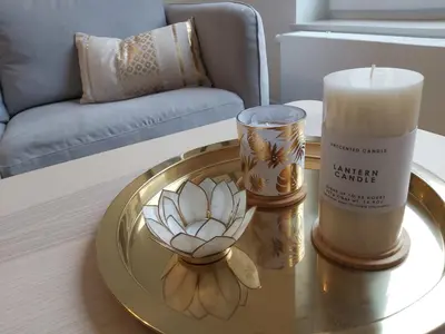 a table with a candle and a candle holder on it at Logement luxueux dans le coeur de Bruxelles in Brussels