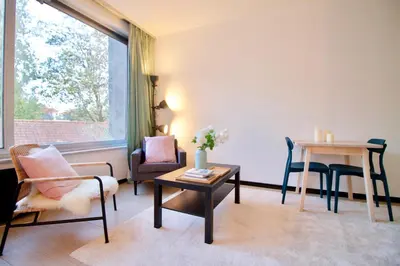 a living room with chairs and a table and a window at Amazing & cosy studio perfect location 'Stephanie-Louise area' in Brussels