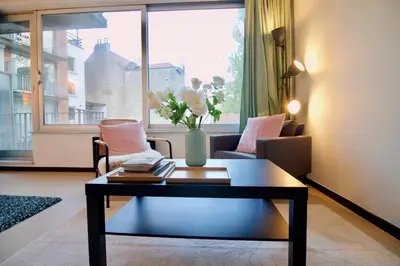 a living room with a coffee table in front of a window at Amazing & cosy studio perfect location 'Stephanie-Louise area' in Brussels