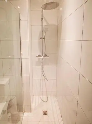 a shower with a glass door next to a toilet at Amazing & cosy studio perfect location 'Stephanie-Louise area' in Brussels
