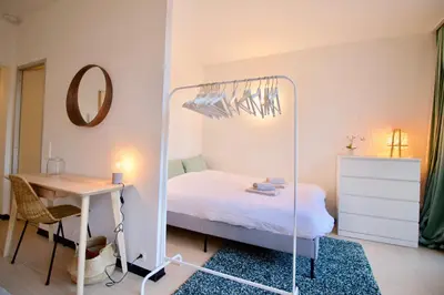 a bedroom with a mirror and a bed and a desk at Amazing & cosy studio perfect location 'Stephanie-Louise area' in Brussels