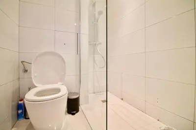 a white bathroom with a toilet and a shower at Amazing & cosy studio perfect location 'Stephanie-Louise area' in Brussels