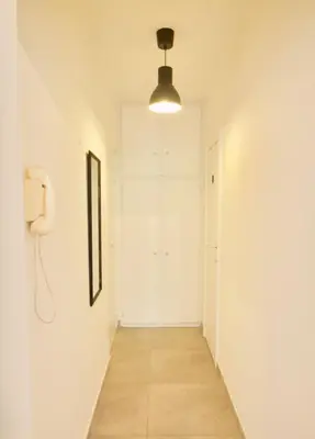 a hallway with a phone and a white wall at Splendid & cosy studio - perfect location 'Stephanie-Louise area' in Brussels