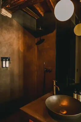 a bathroom with a bowl sink on a counter at Nonam Boutique Hotel Gent in Ghent